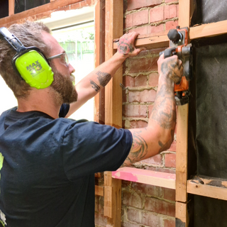 Builder working on framing in renovation project