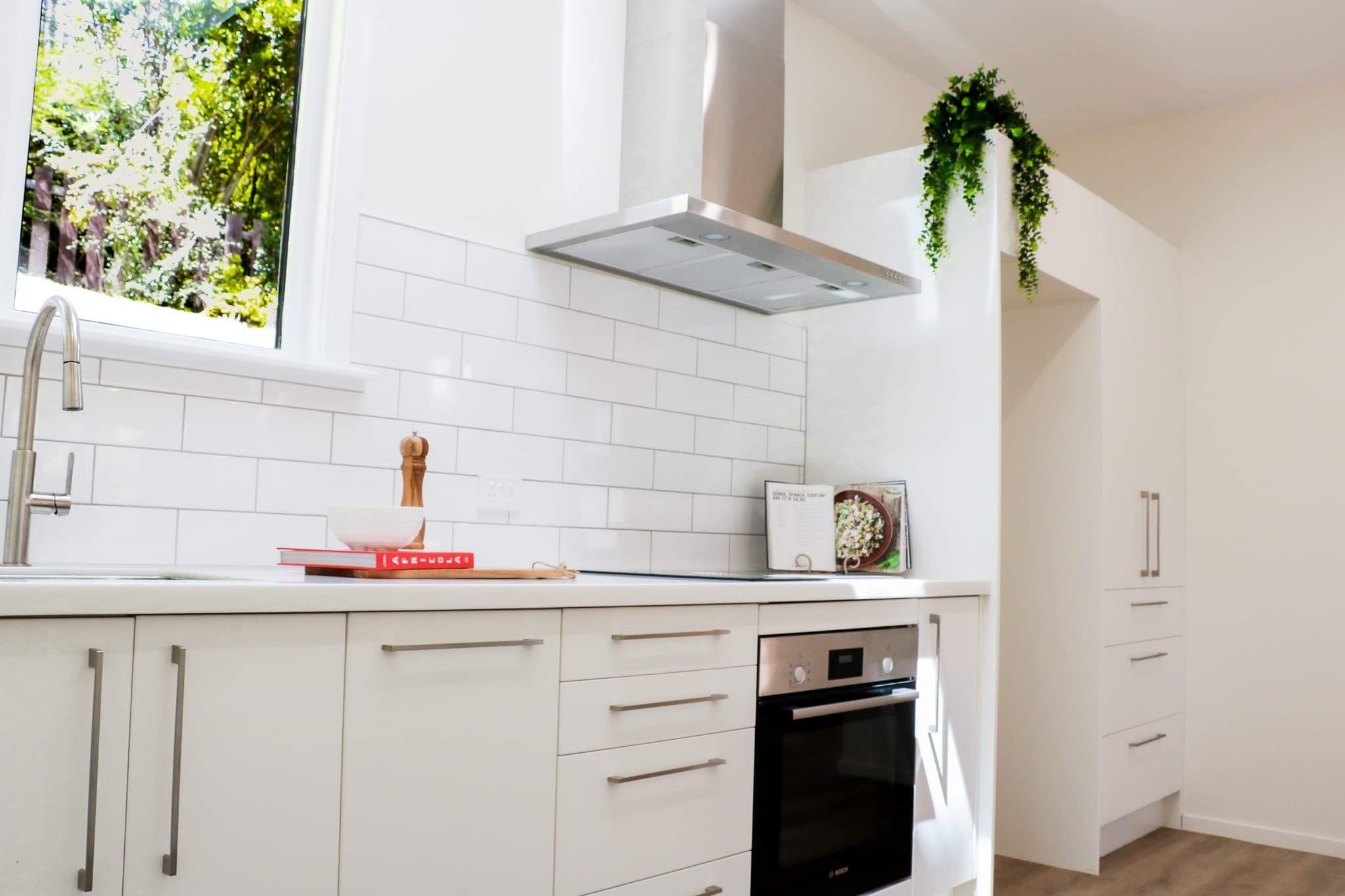 Newly renovated kitchen with white subway tiles, new appliances and styled.