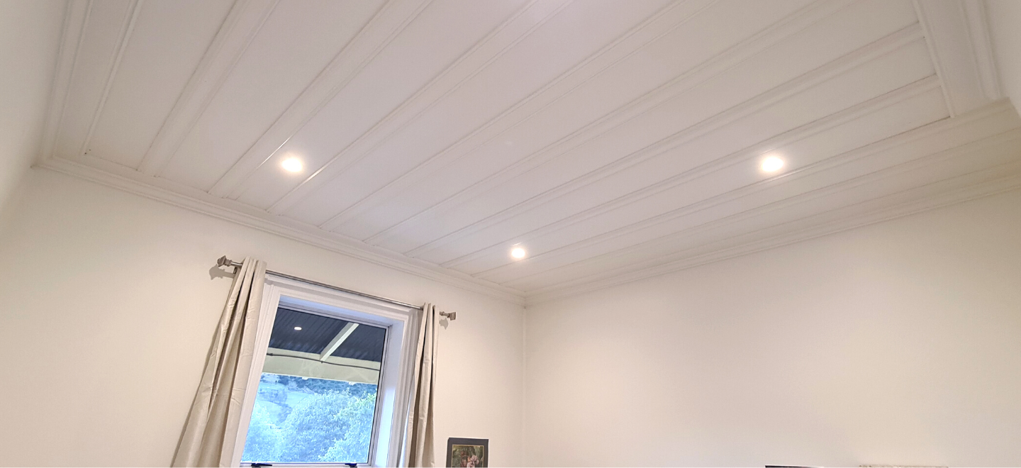 Looking up at fresh ceiling with new downlights in a new renovation